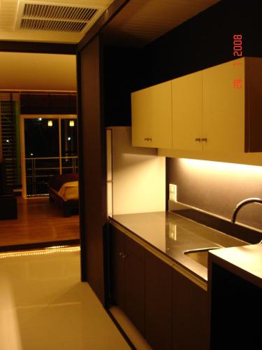 a kitchen with a view of a living room at room 5 pattaya tower in Pattaya