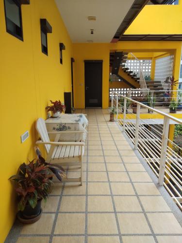 a balcony of a house with a yellow wall at room 5 pattaya tower in Pattaya