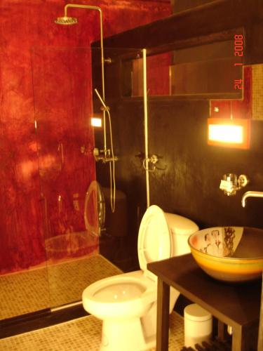 a bathroom with a toilet and a glass shower at room 5 pattaya tower in Pattaya
