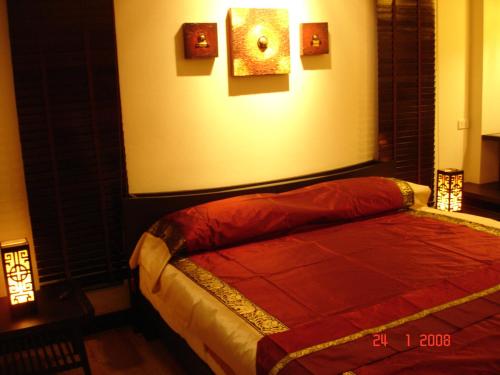 a bedroom with a bed with a red blanket on it at room 5 pattaya tower in Pattaya Central