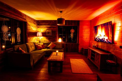 a living room with a couch and a fireplace at Osada Koniaków in Koniaków