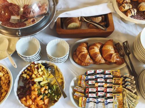 a table topped with different types of food and pastries at San Teodoro in Korčula