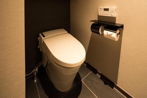 a bathroom with a white toilet in a stall at barhotel Hakone Kazan in Hakone