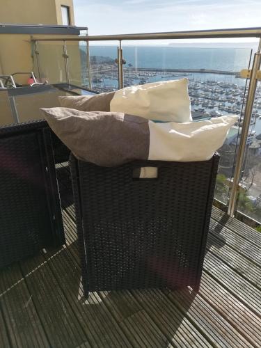 a balcony on a ship with two pillows at Panoramic sea views, sleeps 4, Torquay in Torquay