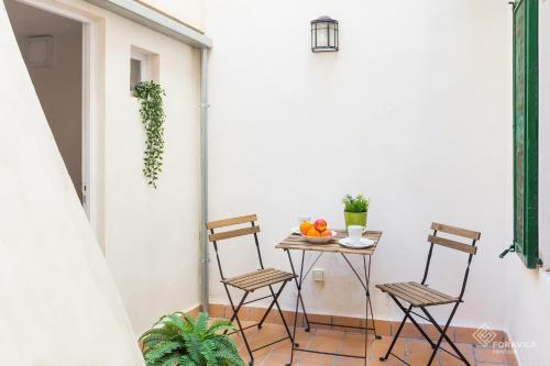 a small table with two chairs on a balcony at S'Estacio in Bunyola