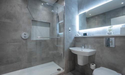 a bathroom with a shower and a toilet and a sink at Temple Gate Hotel in Ennis