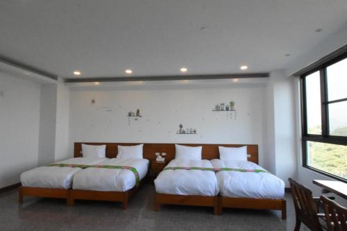 Una cama o camas en una habitación de 巨缿民宿巨象民宿