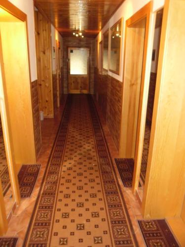 a hallway with a tiled floor in a building at Privát Nataša in Nová Lesná