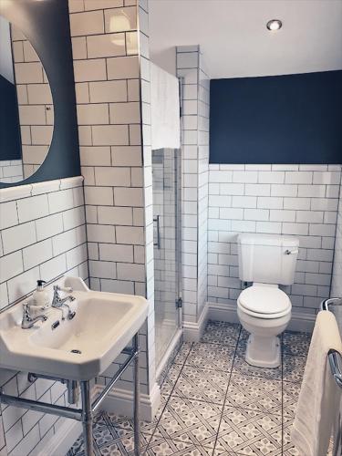 a bathroom with a white toilet and a sink at No.03 Cottage in Strathkinness