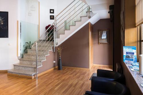 a staircase in a living room with a stair case at Hotel San Lázaro in Santiago de Compostela