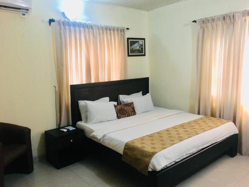 a bedroom with a large bed in a room at Light House Hotel in Lekki