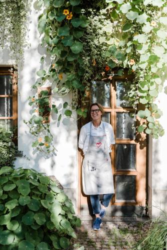 a woman is standing in front of a window at Sommers Hotel Altes Posteck in Reichenbach im Vogtland