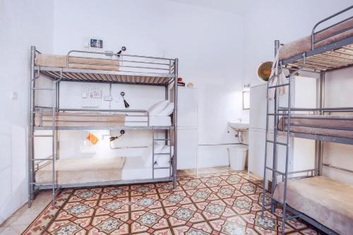 a room with two bunk beds and a toilet at Granny's Inn Hostel in Sliema