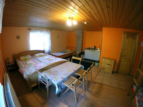 a bedroom with a bed and a table and chairs at Küljemäe puhkemaja in Otepää