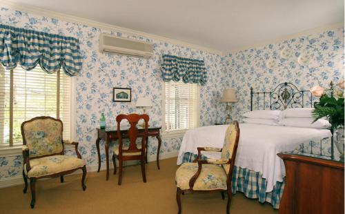 a bedroom with a bed and a table and chairs at Lambertville House in Lambertville