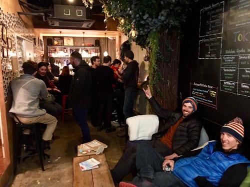 a group of people sitting in a bar at Hostel Bedgasm in Tokyo