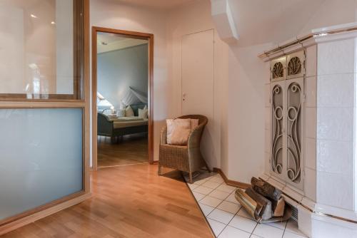 a living room with a fireplace and a mirror at Landhaus Sonnenhof in Adenau