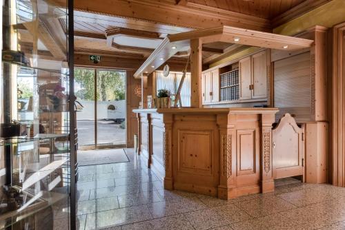 an open kitchen with wooden cabinets and a large island at Landhaus Sonnenhof in Adenau