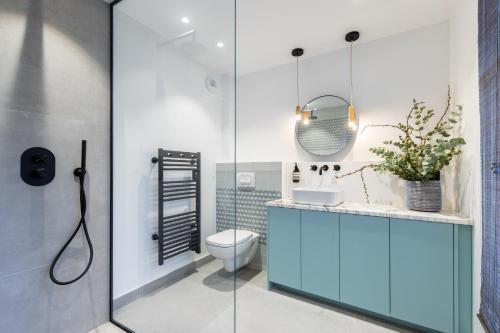 a bathroom with a toilet and a glass shower at L'Abeille - Boutique Apartments in Nice