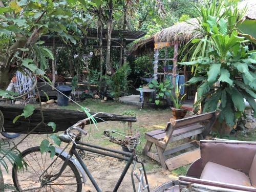 a bike parked next to a bench and a chair at Freedom home in Ko Chang