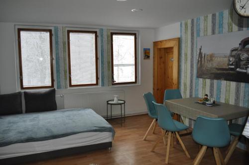 a bedroom with a bed and a table and chairs at Apartmány CENTRUM in Rajecké Teplice