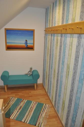 a living room with a blue couch and a rug at Apartmány CENTRUM in Rajecké Teplice