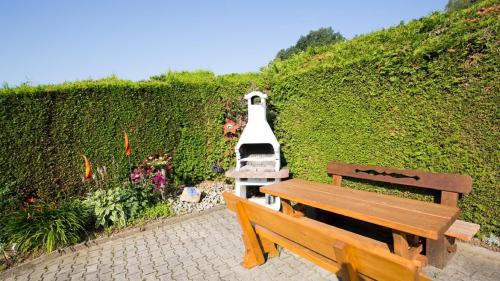 a boat is parked next to two benches at Haus Osserblick in Arrach