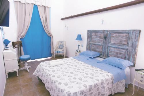 a bedroom with a large bed with a wooden headboard at Casa Antonia in Naples
