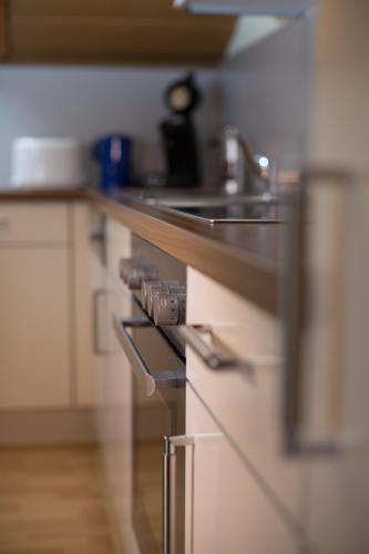 a kitchen with a stove and a sink in it at Haus Osserblick in Arrach