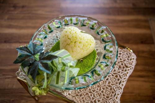 a glass plate with a heart shaped cookie on a table at Haus Osserblick in Arrach