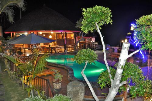 a resort with a swimming pool at night at Ocean Terrace Suite And Spa Luxury in Nusa Penida
