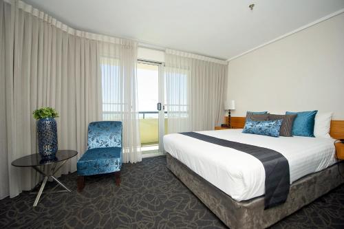a hotel room with a bed and a chair at The Lord Forrest Hotel in Bunbury