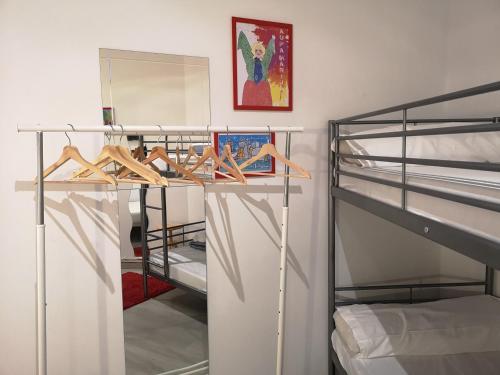 a bedroom with two bunk beds and a mirror at Pil Pil Hostel Bilbao in Bilbao