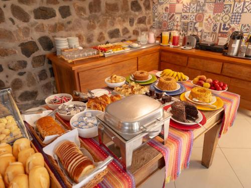 a table with a bunch of food on it at Pousada Perequê in Ilhabela