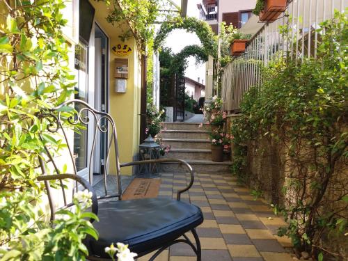 a bench sitting on a sidewalk in front of a building at Residence Domaso in Domaso
