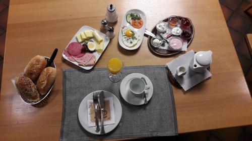 a table with plates of breakfast food on it at Gasthof Zur Krone in Leidersbach