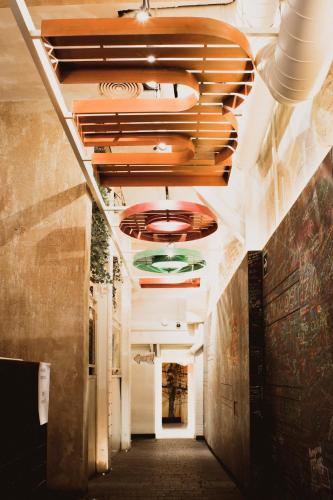 a hallway in a building with a ceiling at room00 Chueca Hostel in Madrid
