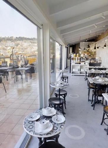 a restaurant with tables and chairs with a view at The ART INN Lisbon in Lisbon