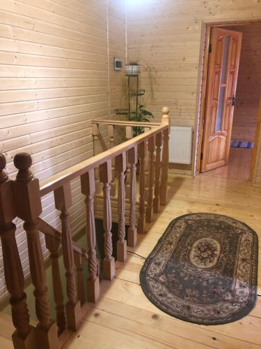 a staircase with a rug on the floor and a door at Sadyba Domashniy zatyshok in Pilipets