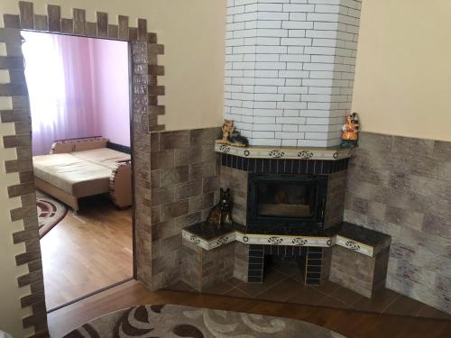 a living room with a fireplace and a mirror at Sadyba Domashniy zatyshok in Pilipets