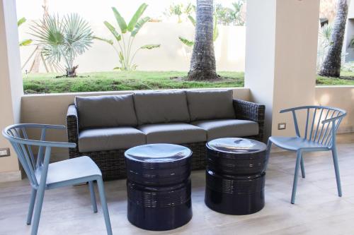 a couch and two chairs and two stools at Casa Marina Beach & Reef All Inclusive in Sosúa