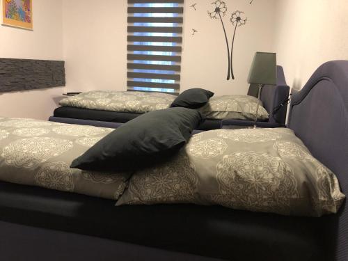 a bedroom with two beds and a bed frame at Messezimmer 4u in Düsseldorf