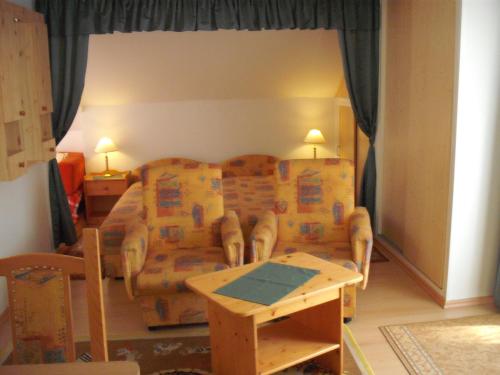 a living room with a couch and a table at Apart Hévízi Ház in Hévíz
