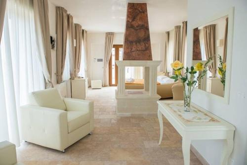 a living room with a chair and a table at Agriturismo I Pozzetti in Savelletri di Fasano