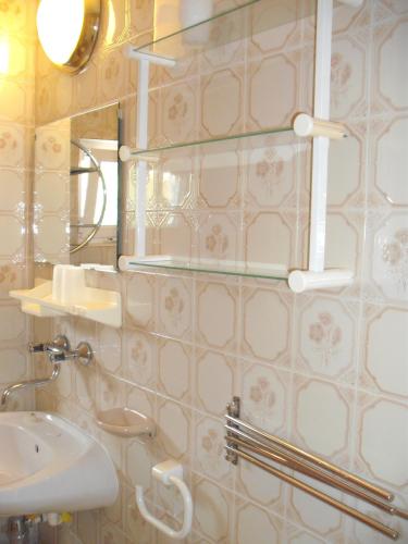 a bathroom with a sink and a mirror at Apart Hévízi Ház in Hévíz