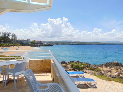 a balcony with chairs and a view of a beach at Casa Marina Beach & Reef All Inclusive in Sosúa