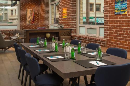 a dining room with a long table and blue chairs at The Mark Spencer Hotel in Portland