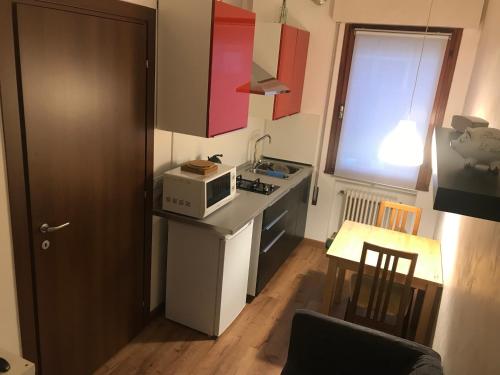a small kitchen with a stove and a microwave at Portello in Padova