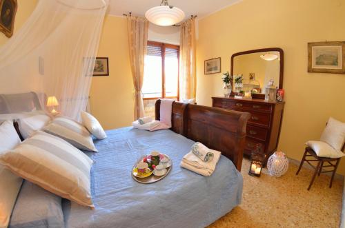 a bedroom with a bed with a plate of food on it at Carnevale in Viareggio