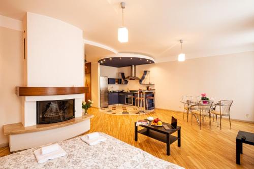 a living room with a fireplace and a table at Old Riga Aldaru street Apartment 2 in Riga